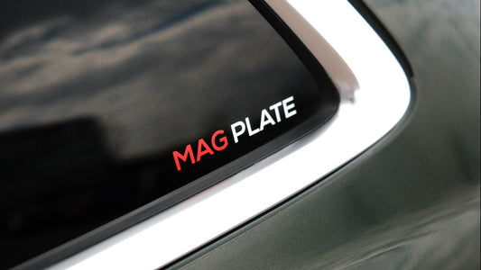 Decal on a car window with 'MAG PLATE' text
